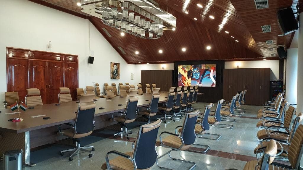 Conference table at the Chief Minister's Residential Complex, Kohima — boundary microphones at each seating position.