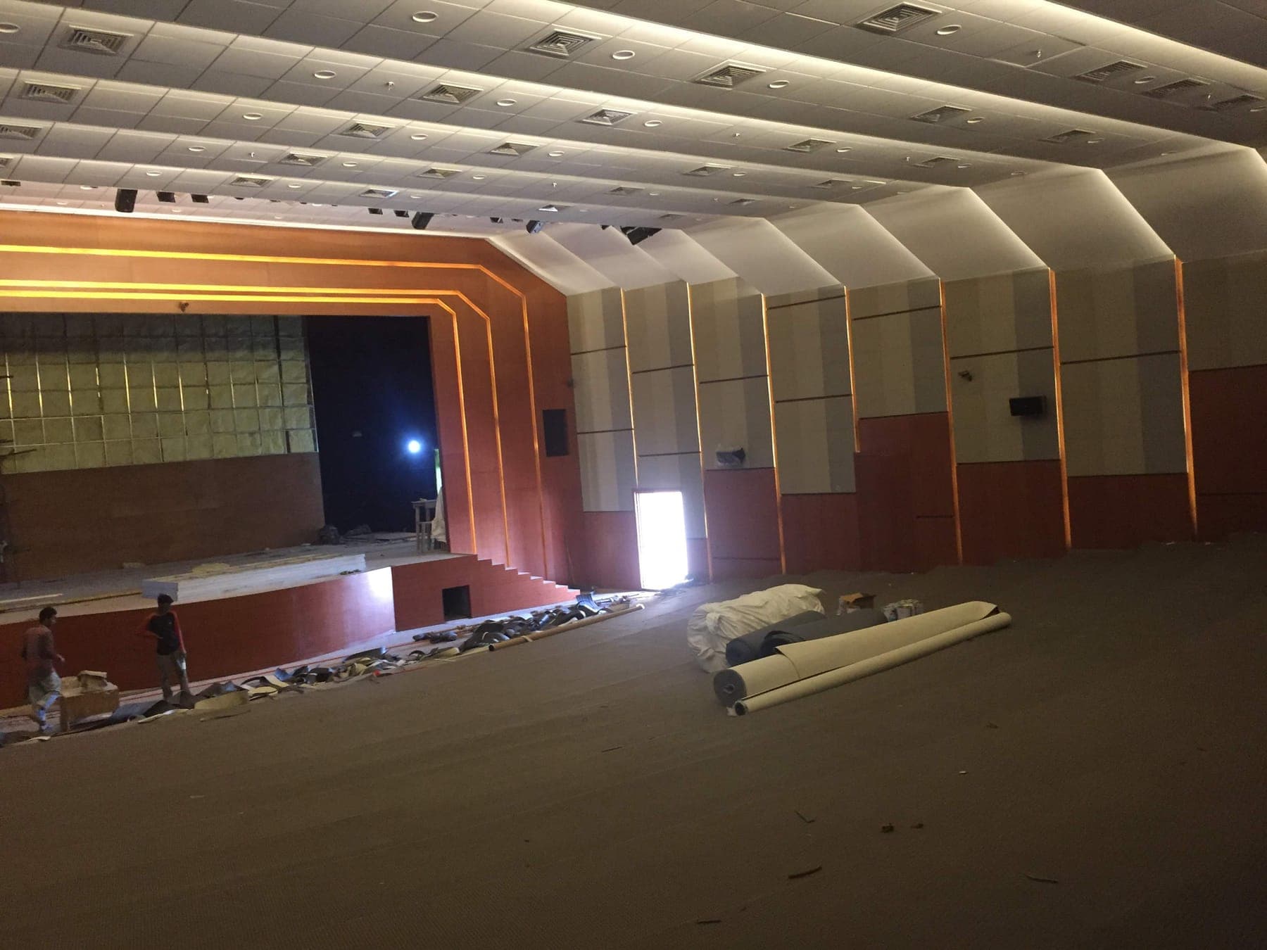 Namsai Multipurpose Cultural Hall acoustic wall treatment along the auditorium with the stage apron, during installation.