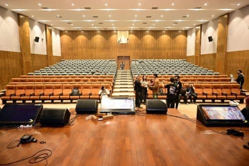 Town Hall auditorium Dimapur — orange seats, stage monitors