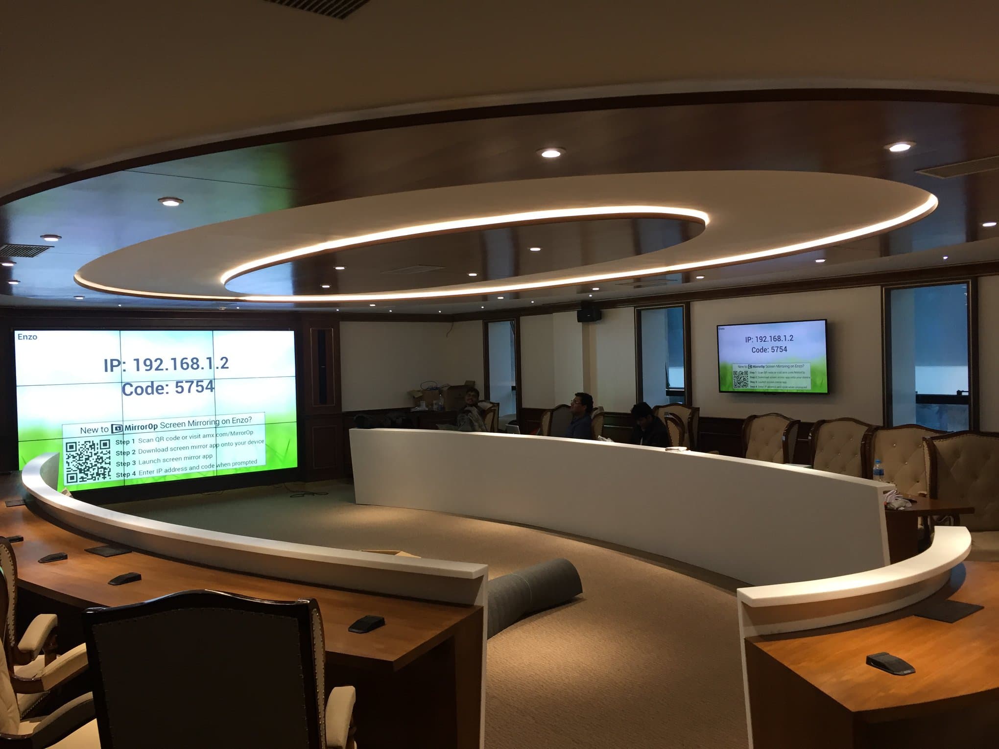 3x3 LG fine-pitch video wall showing AMX Enzo screen mirroring with 55-inch side display showing matching pairing code