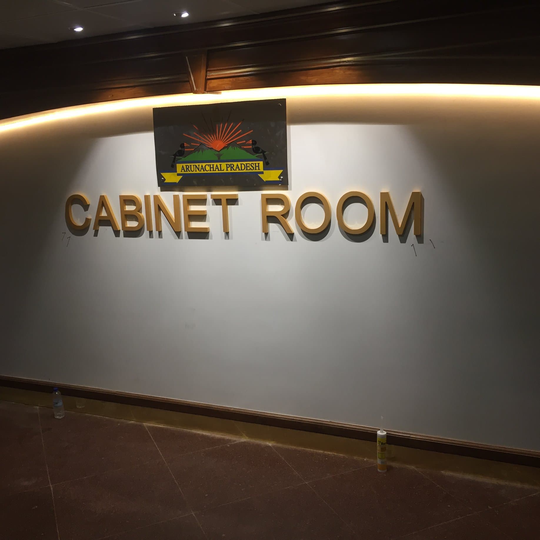 Cabinet Room entrance signage with Arunachal Pradesh state emblem and warm cove lighting