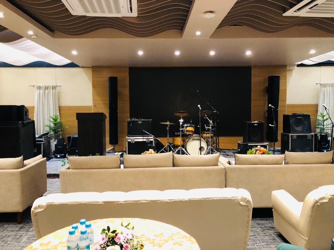 Taraghar conference hall stage with JBL line array, subwoofer and monitor speaker setup
